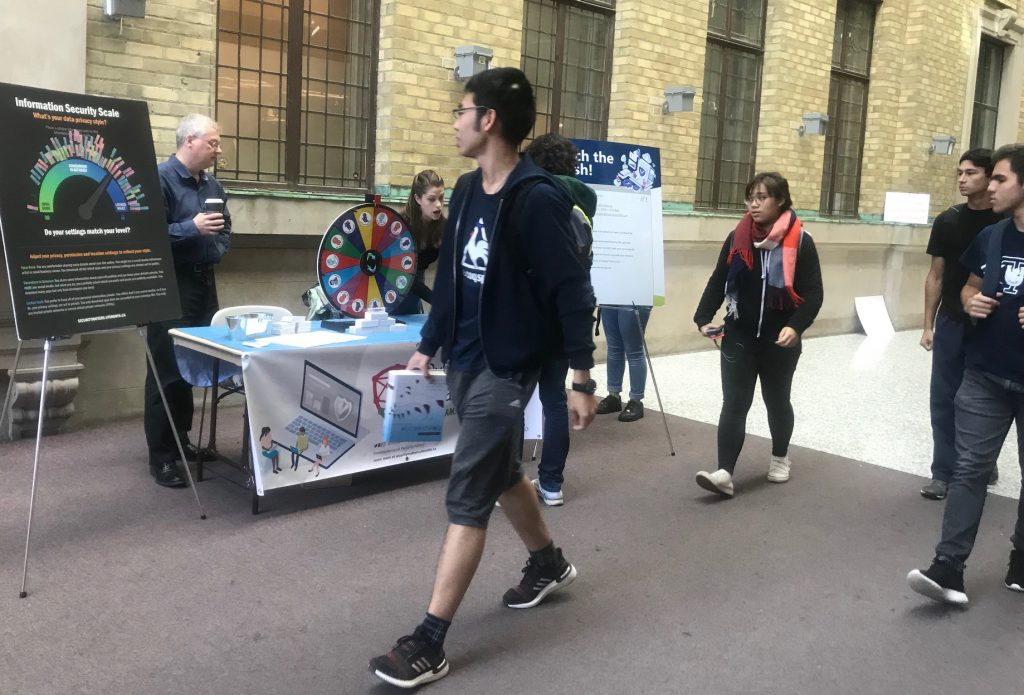 CSAM 2019 booth with students walking by at Bahen Centre