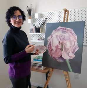 Maryam Shafiei pictured with her art work: a painting of a pink flower