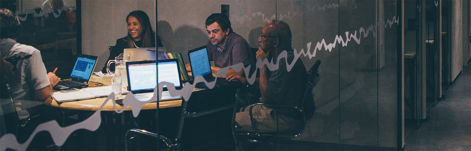 Staff working together in a huddle room.