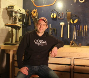 Matt Wilks sitting in his woodworking shop