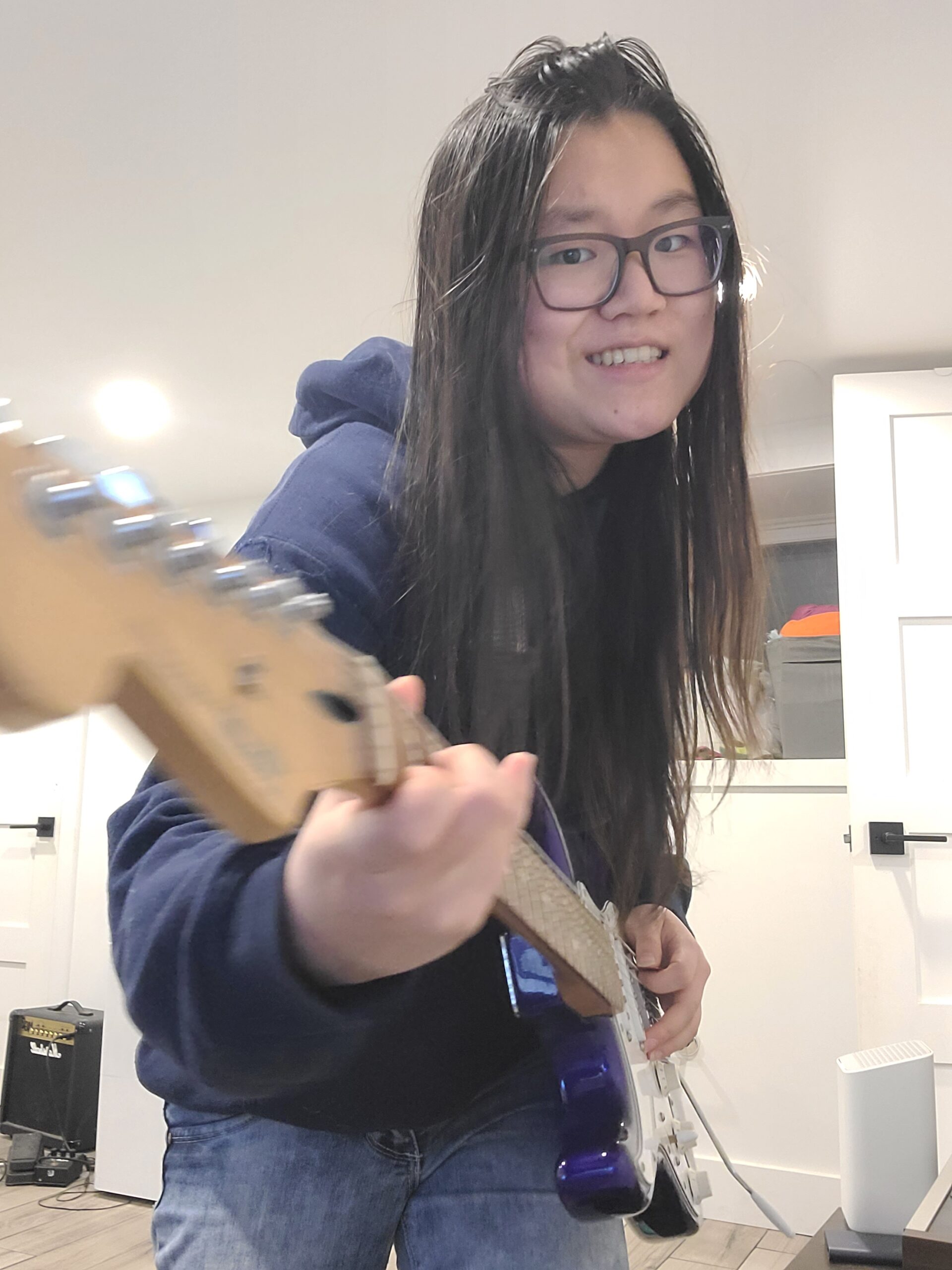 Stephanie Yang playing a guitar.