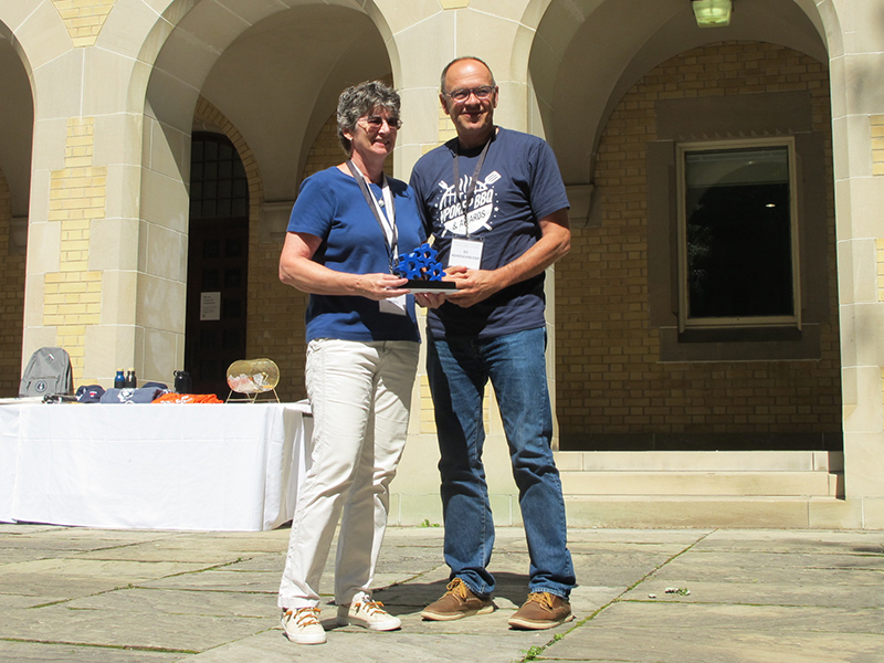 Cathy Eberts receiving the distinguished service award from Bo Wandschneider.