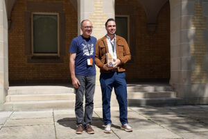 Michael Laurentius receiving the Individual Impact Award from Bo Wandschneider