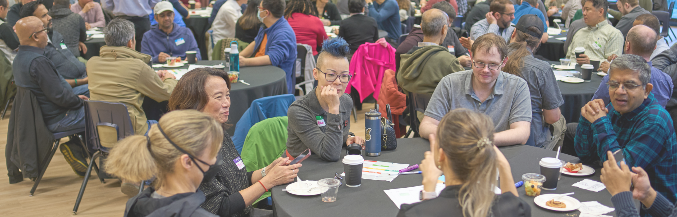 Staff members collaborating in a town hall discussion