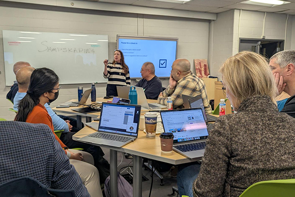 People listening to a presentation at a workshop